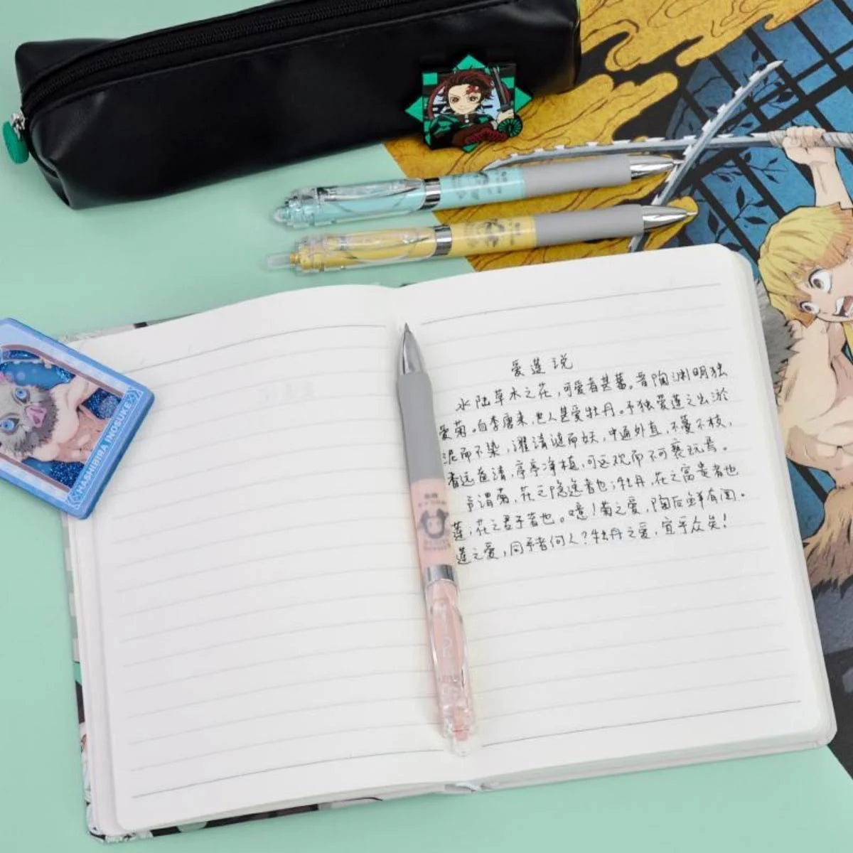 Tanjiro, Nezuko, Zenitsu & Inosuke Anime Stationery Set Gift Bag: Including Gel Pens, Pen Pouch, Notebook and Anime Poster